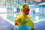 large duck statue next to an indoor pool
