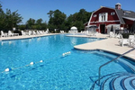pool with a red barn style pool house